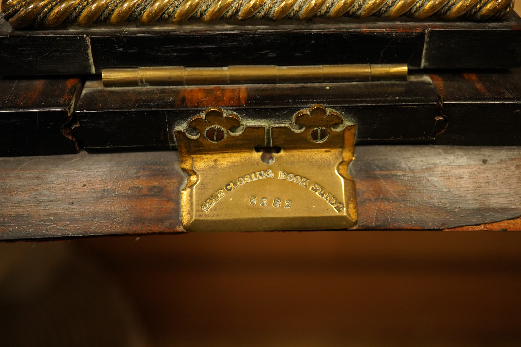 A Victorian coromandel and porcelain mounted book slide, stamped Betjemann's Patent. 68cms fully extended., Condition - poor, some veneer missing